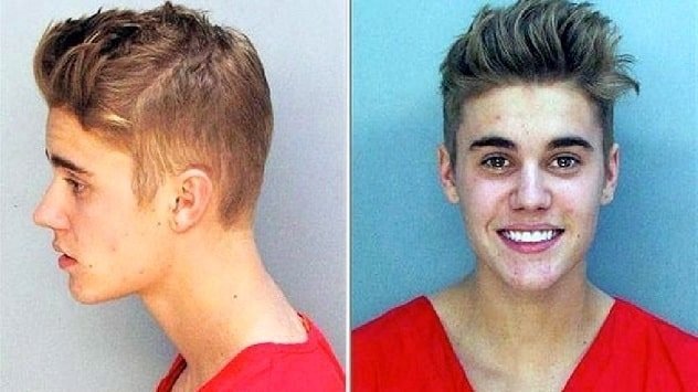 Justin Bieber smiling in his DUI mug shot
