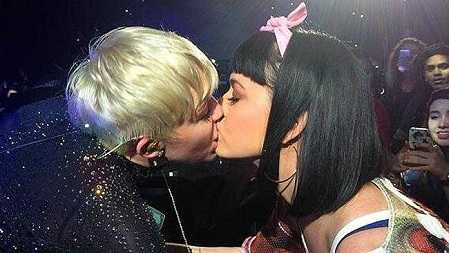 Miley Cyrus smooches Katy Perry during a live performance.