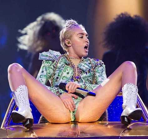 Miley Cyrus masturbating on stage during a live performance.