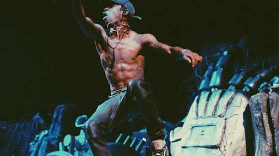 Travis Scott does crazy on stage stunts like diving flying and falling into the crowd